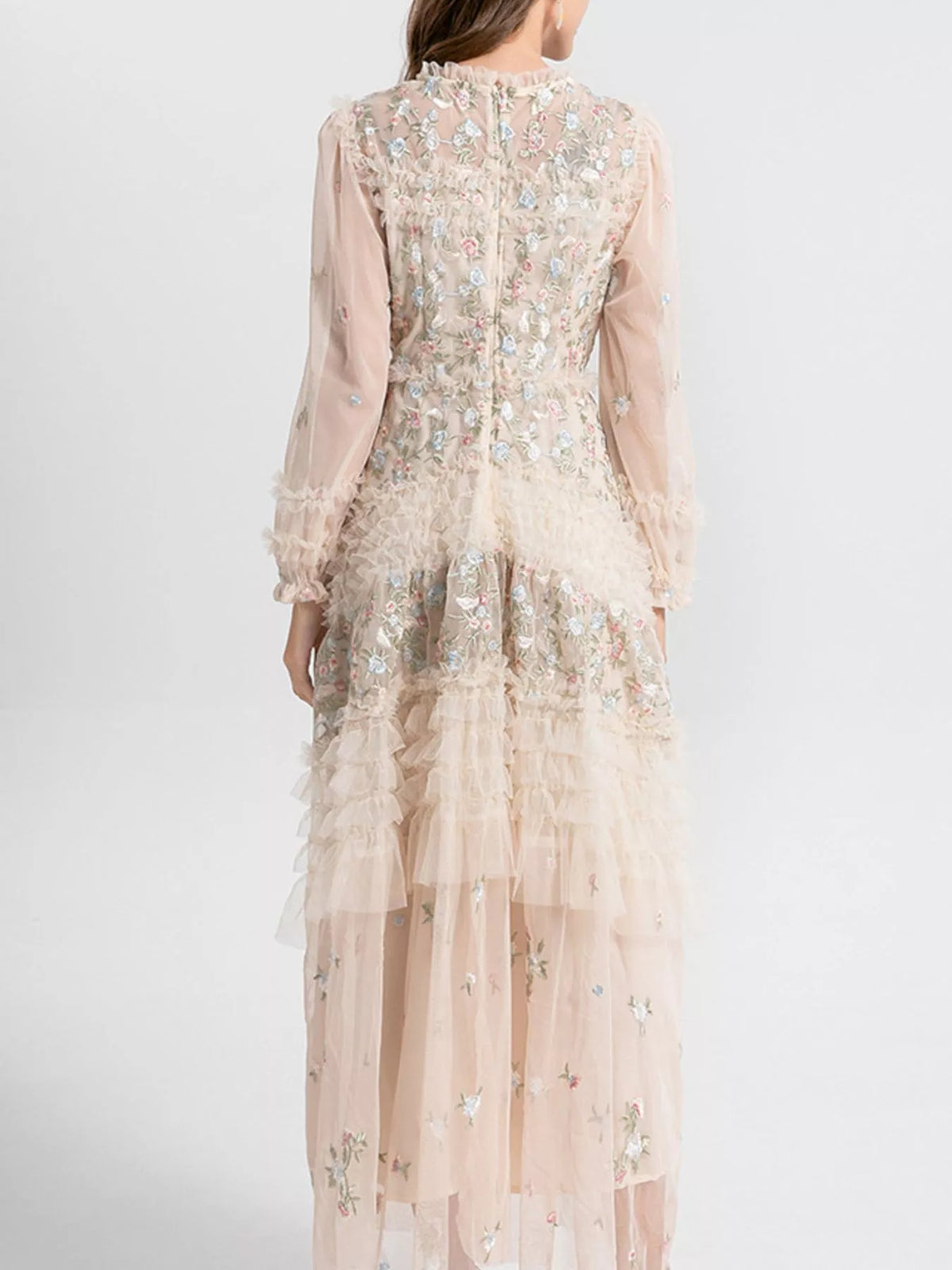Woman wearing an elegant apricot floral tulle maxi dress from Evie's Dreamland