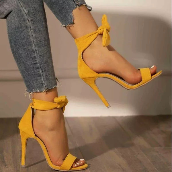 Women's yellow open toe stiletto heel party sandals, angled view