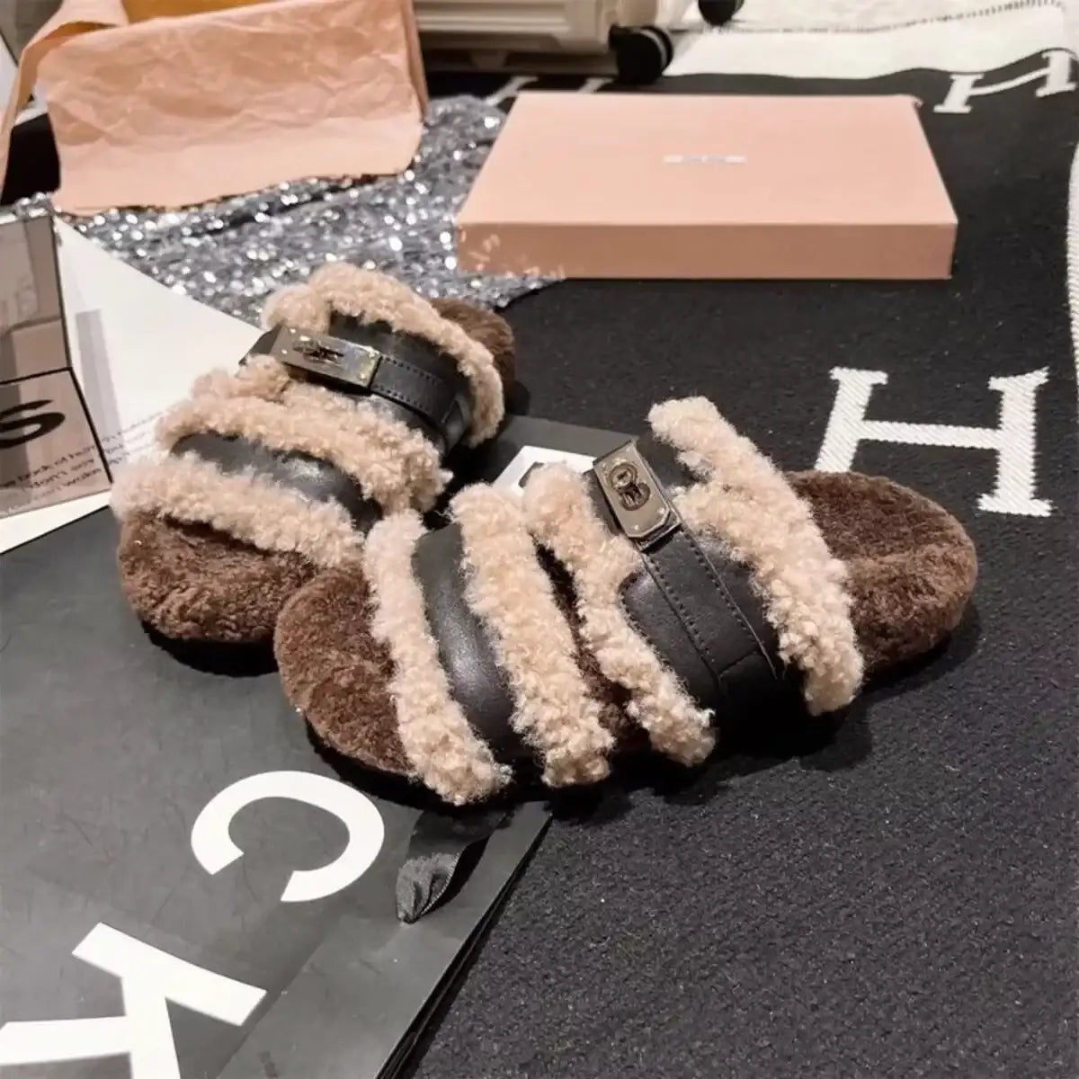 Brown plush faux fur buckle slippers by Evie's Dreamland with adjustable black straps.