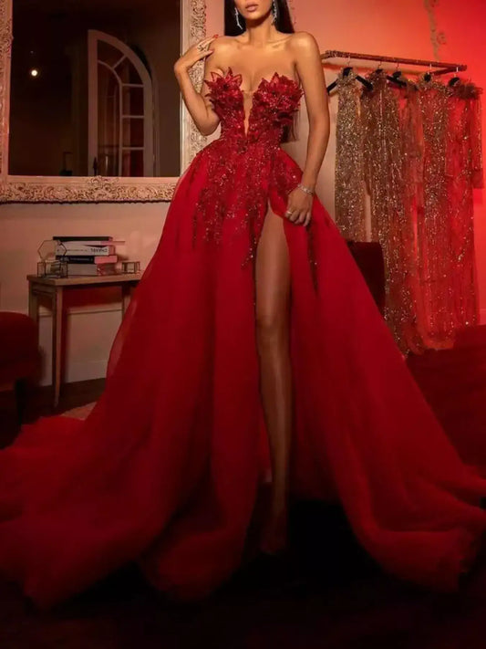 Woman wearing a red sequin high-slit strapless evening gown from Evie's Dreamland