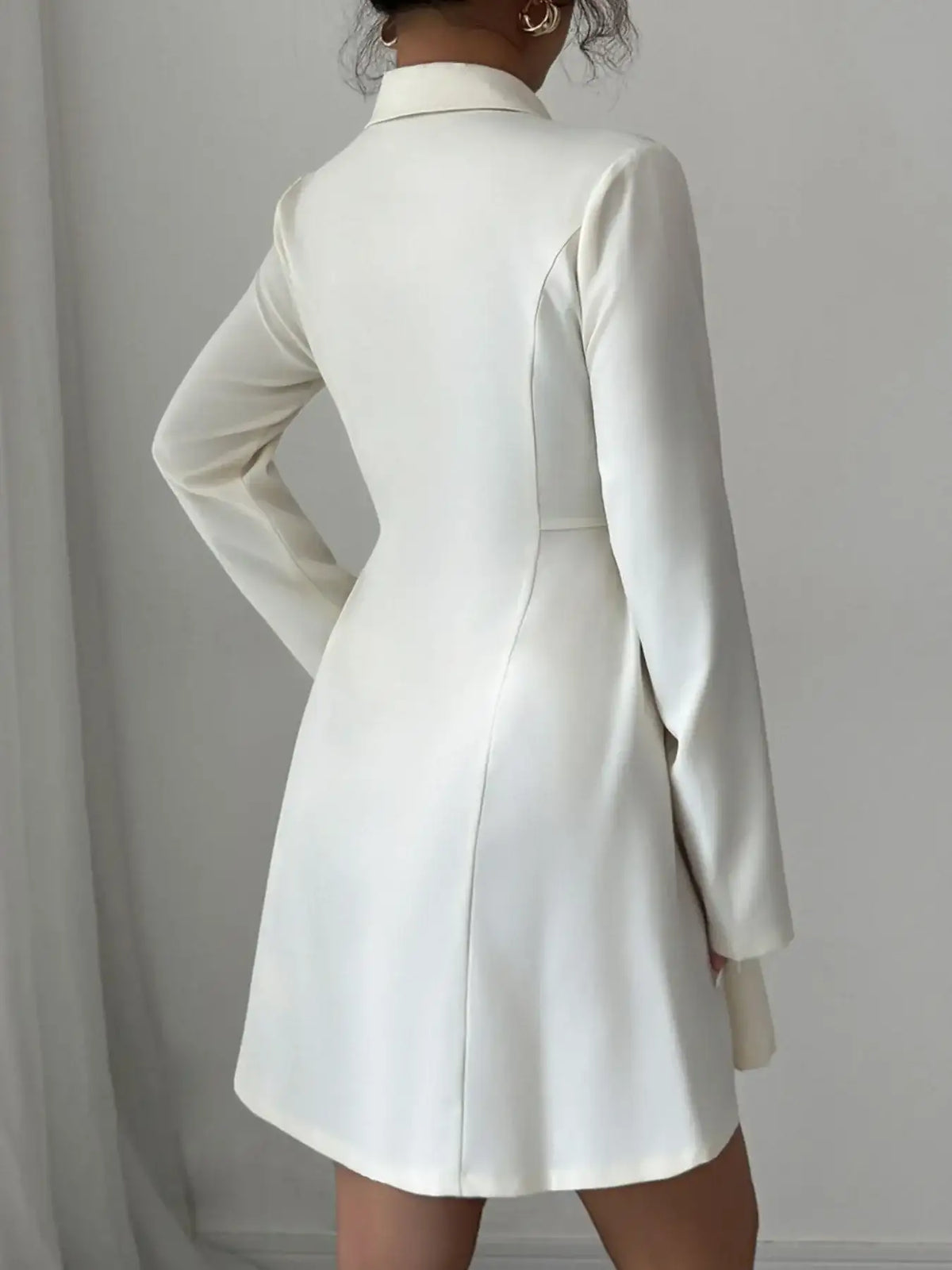 Back view of an Evie's Dreamland white double-breasted blazer dress with long sleeves and a tailored fit.