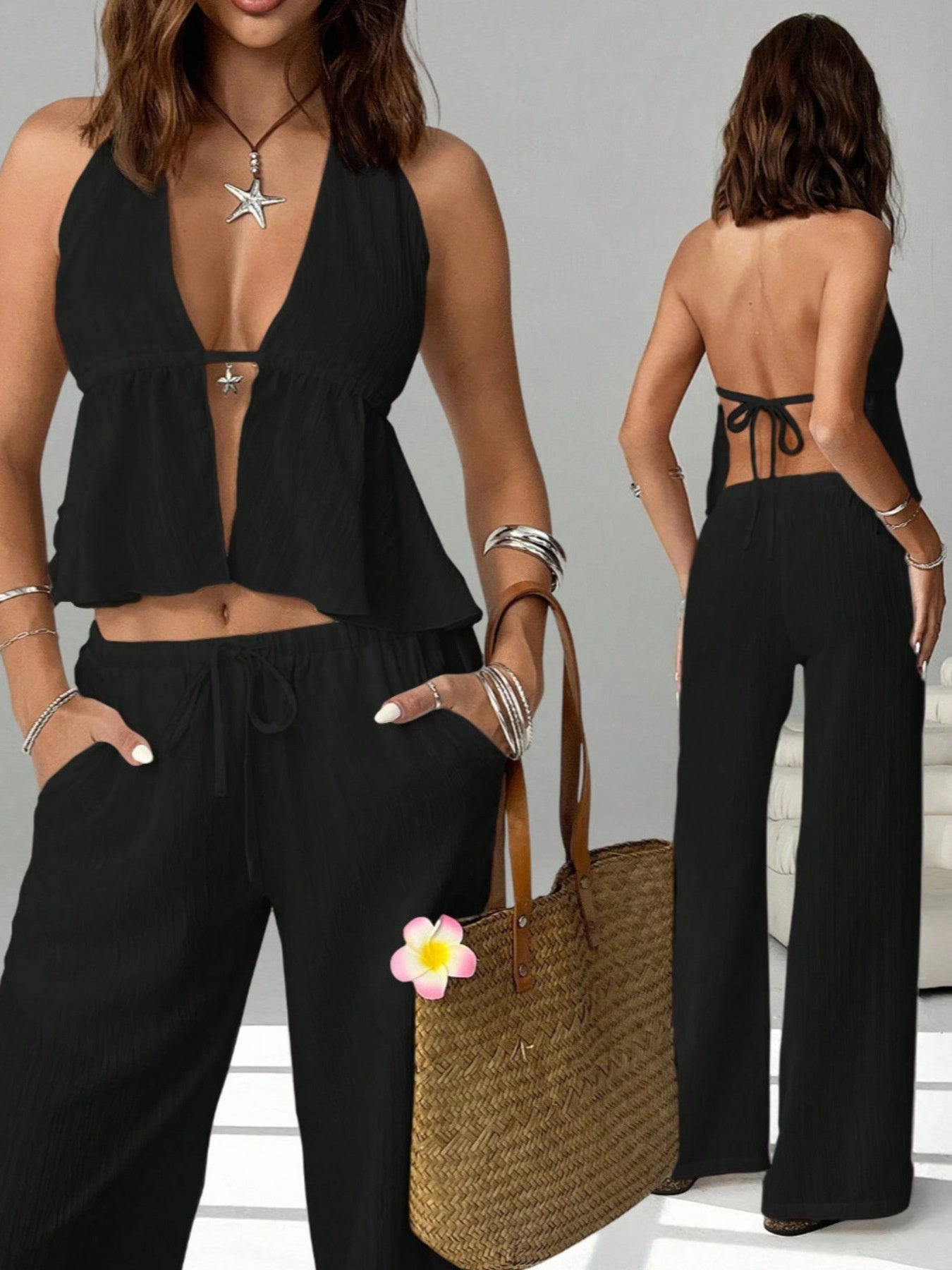 Woman wearing a black halter top and wide-leg pants set, holding a woven straw tote bag.