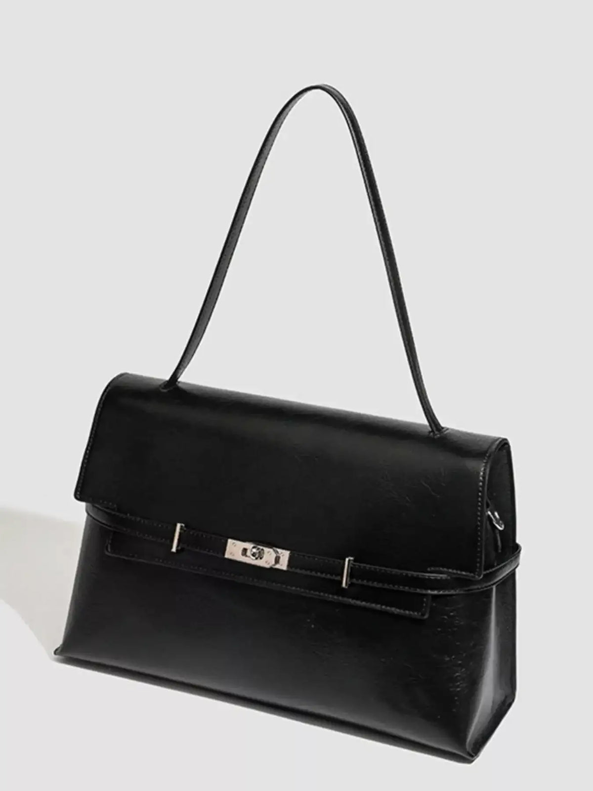Black medium PU leather shoulder bag by Evie's Dreamland featuring a silver buckle closure.
