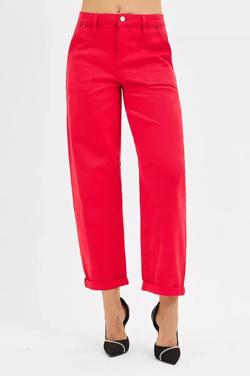Woman wearing bright red cropped pants with cuffed hems and black pointed heels