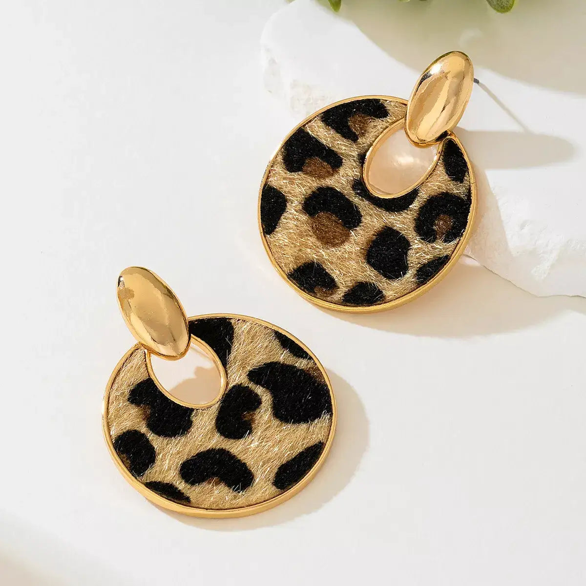 Evie's Dreamland 18K gold-plated circle dangle earrings featuring a brown leopard print pattern.