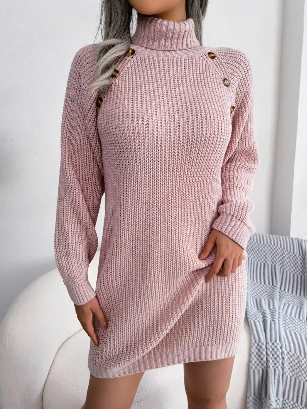 Women's pink knit turtleneck sweater dress by Evie's Dreamland with decorative shoulder buttons.