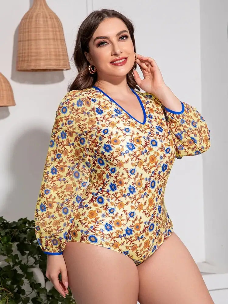 Woman wearing the plus size floral open back one-piece swimsuit, styled for a summer vacation.