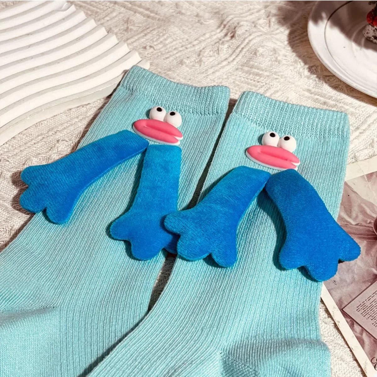 Light blue ribbed socks with 3D blue flipper and pink lips cartoon face design