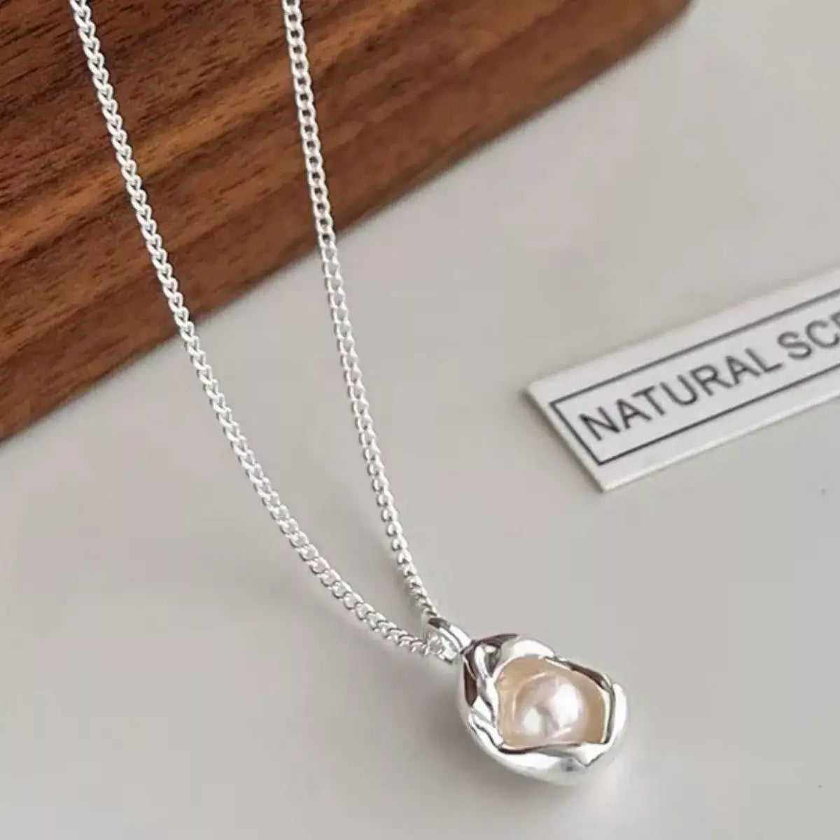 Evie's Dreamland freshwater pearl necklace in 925 sterling silver with a unique organic petal pendant.