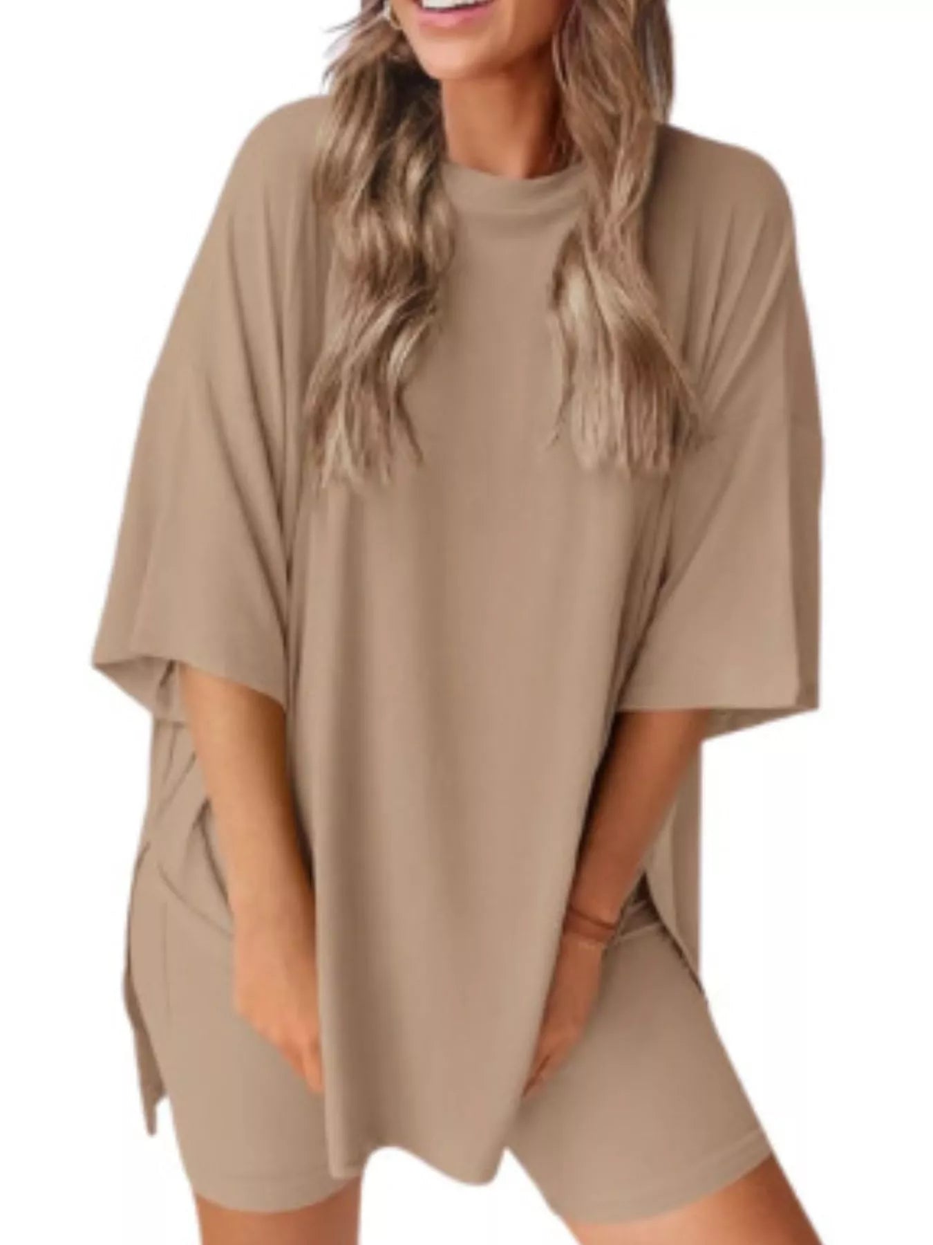 Woman wearing loose beige oversized t-shirt and matching shorts set, cozy loungewear outfit