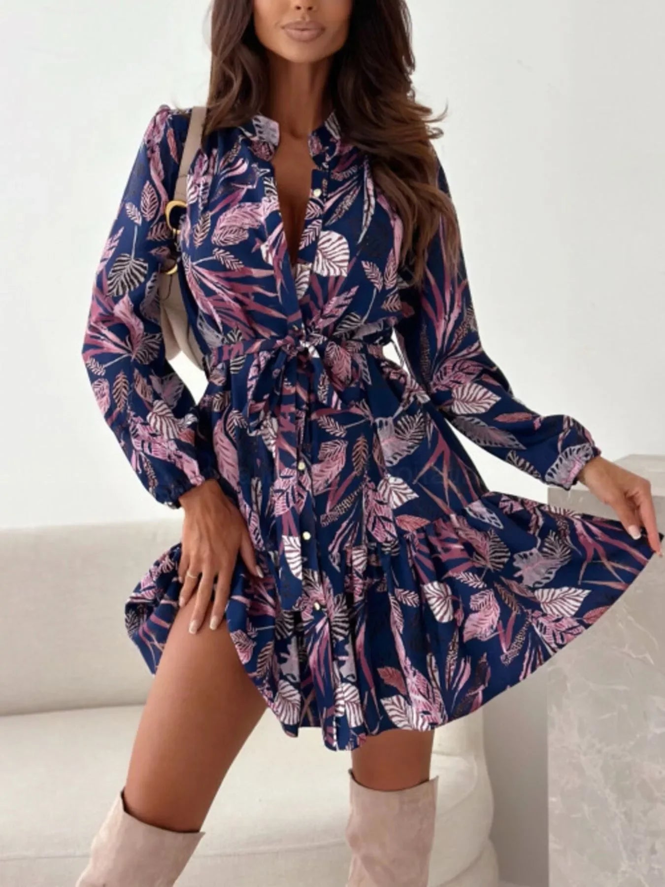 Trendy floral print dress with long sleeves and tie waist, paired with beige boots for chic everyday elegance.