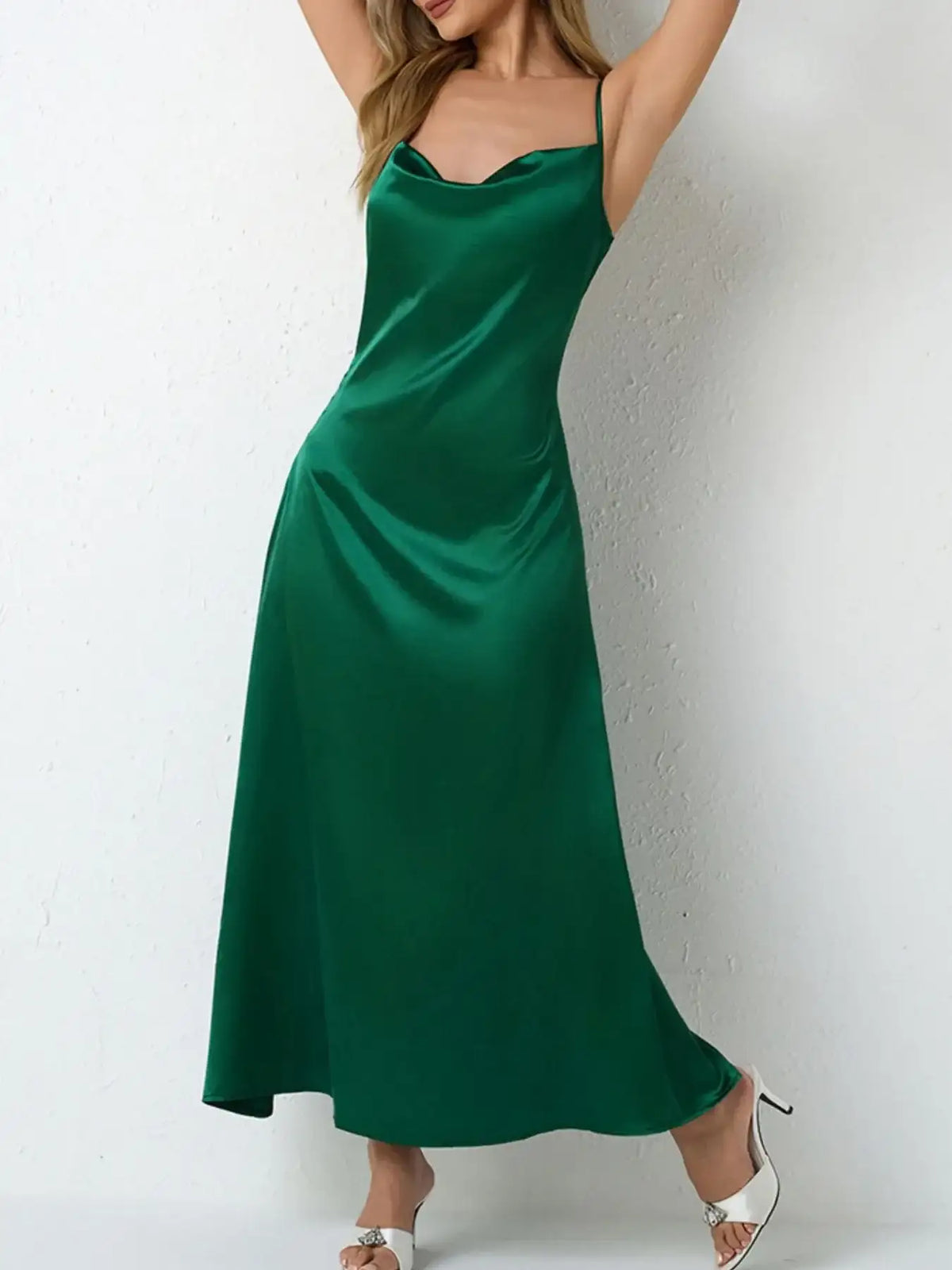 Evie's Dreamland emerald green satin cowl neck slip maxi dress with thin straps and a flowy fit.