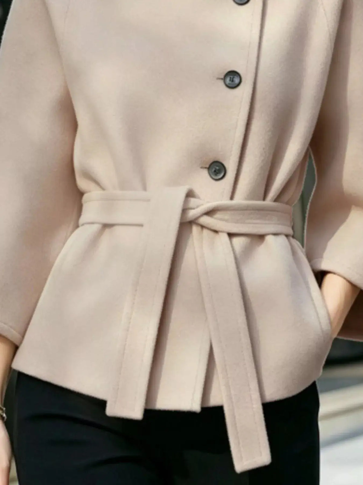 Beige button-down cape coat by Evie's Dreamland featuring a belted waist and a tailored fit.