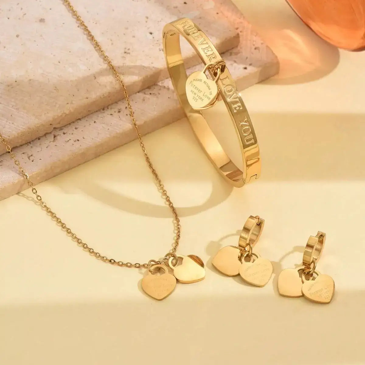 Evie's Dreamland 18K gold-plated heart jewelry set with necklace, bangle, and earrings.