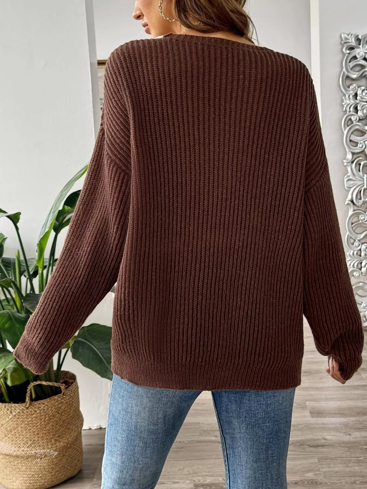 Back view of a brown ribbed knit sweater with long sleeves by Evie's Dreamland, paired with blue jeans.