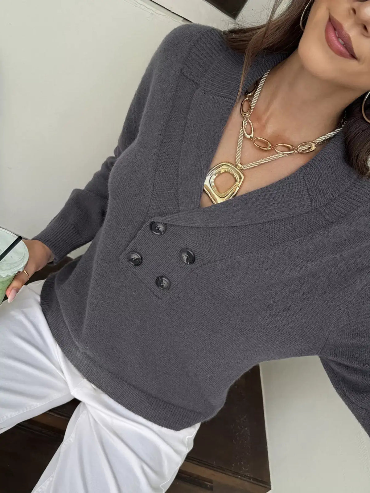Woman wearing a charcoal grey double-breasted shawl collar sweater by Evie's Dreamland and white pants.