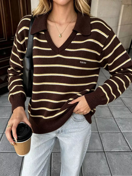 Woman wearing an Evie's Dreamland brown and cream striped polo collar sweater with light wash jeans.