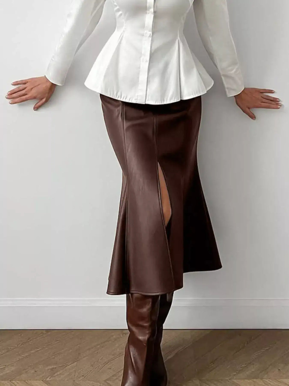Brown faux leather slit mermaid midi skirt by Evie's Dreamland paired with a white peplum top and brown boots.