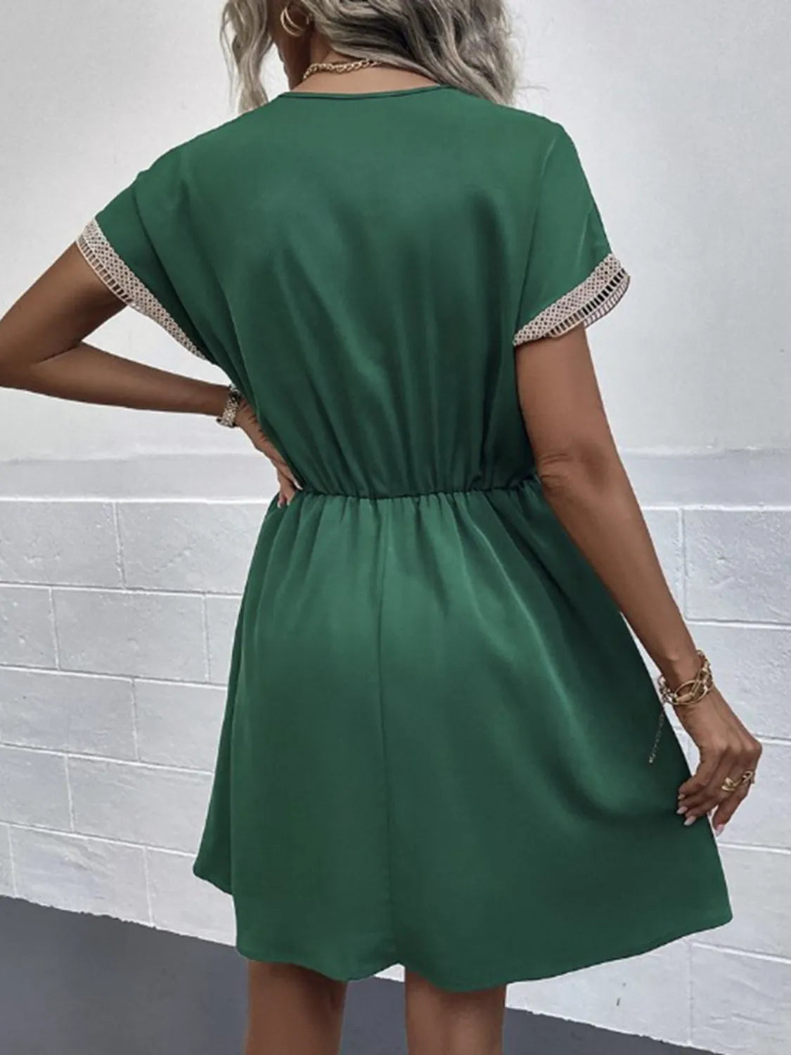Emerald green short sleeve dress with lace trim, elastic waist, and flared skirt for casual chic style.