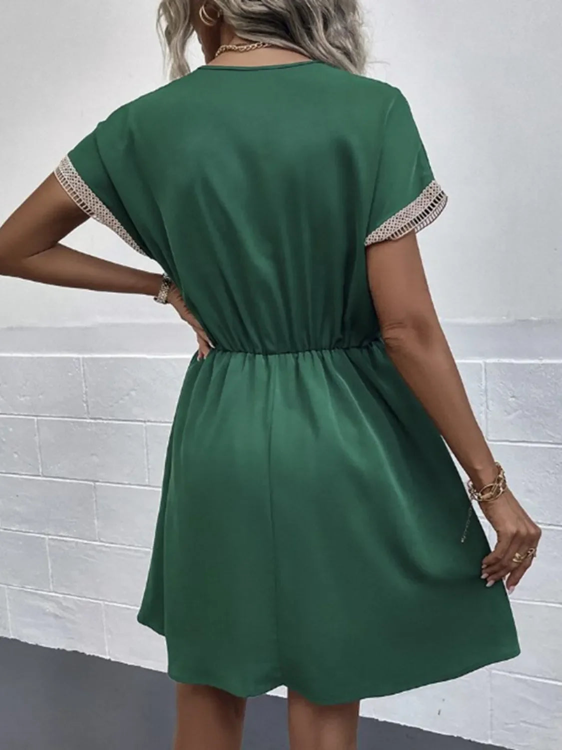 Emerald green short sleeve dress with lace trim, elastic waist, and flared skirt for casual chic style.