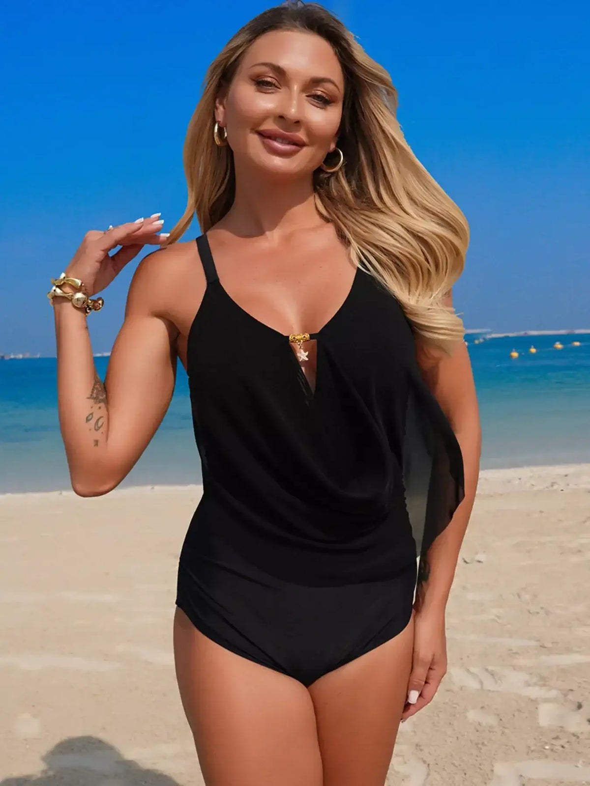 Woman wearing the ruched solid one-piece swimsuit, styled for summer.