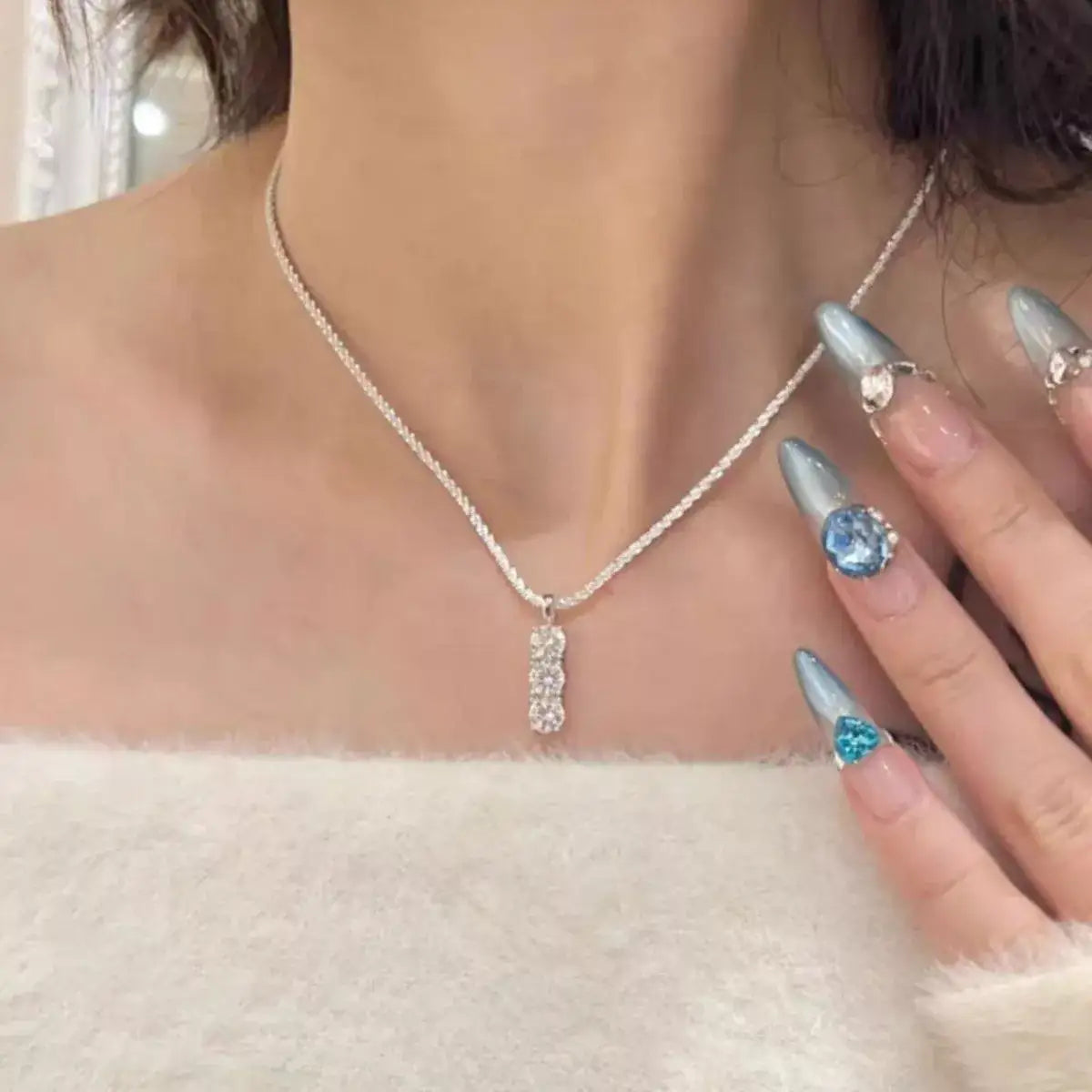 Evie's Dreamland Moissanite 925 sterling silver bar necklace with sparkling stones on a woman.