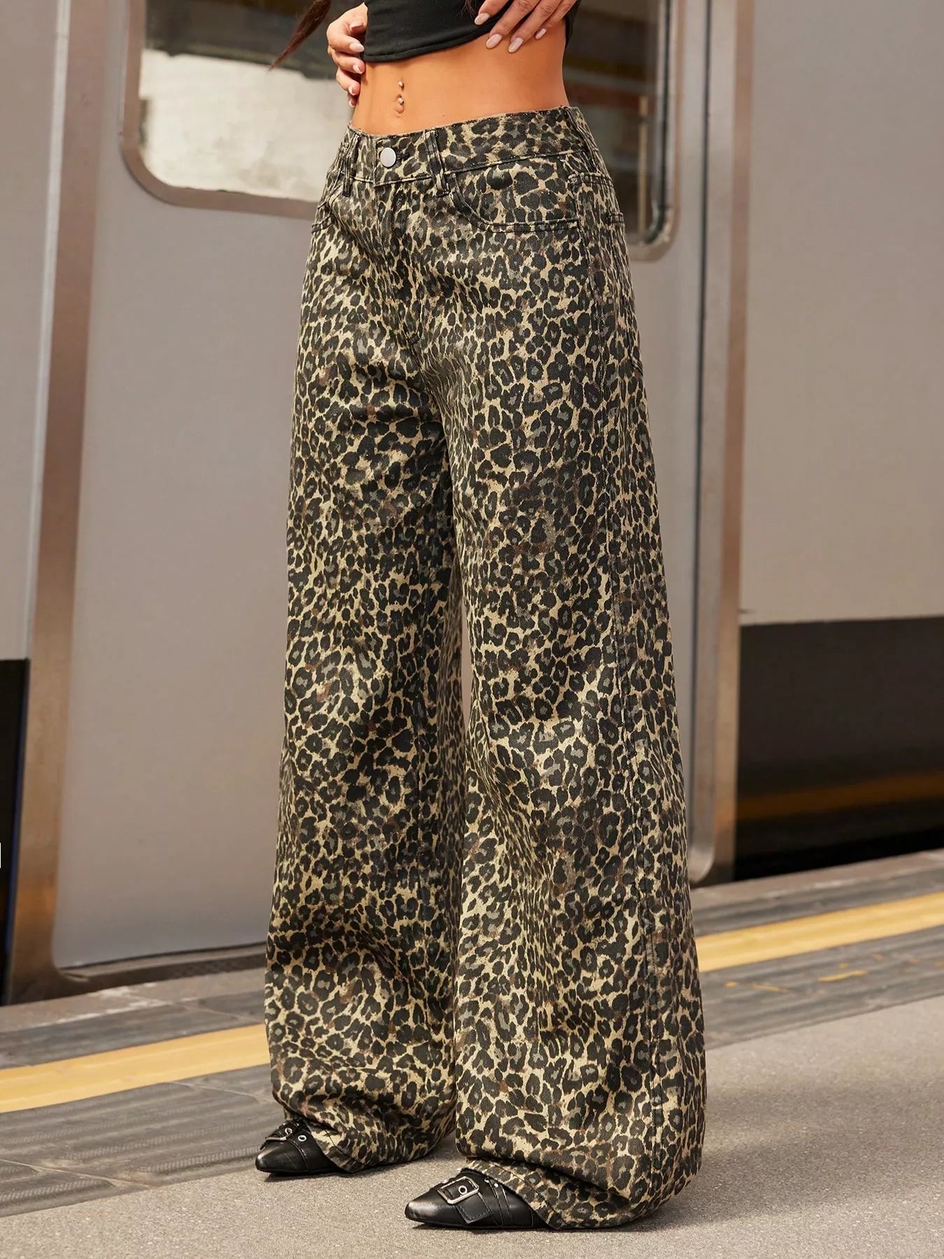 Leopard print wide-leg pants paired with black top and shoes, styled for urban chic fashion.