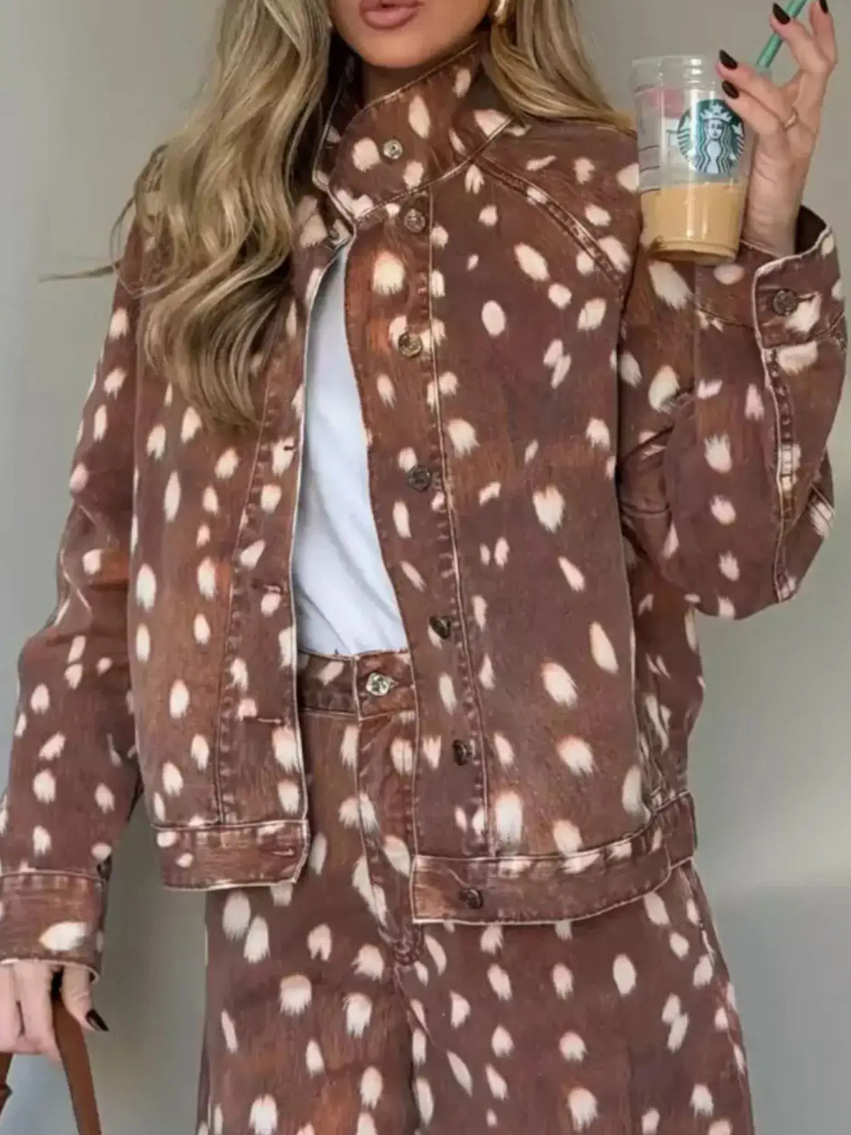 Woman wearing a brown fawn-print button-down denim jacket from Evie's Dreamland with matching pants.