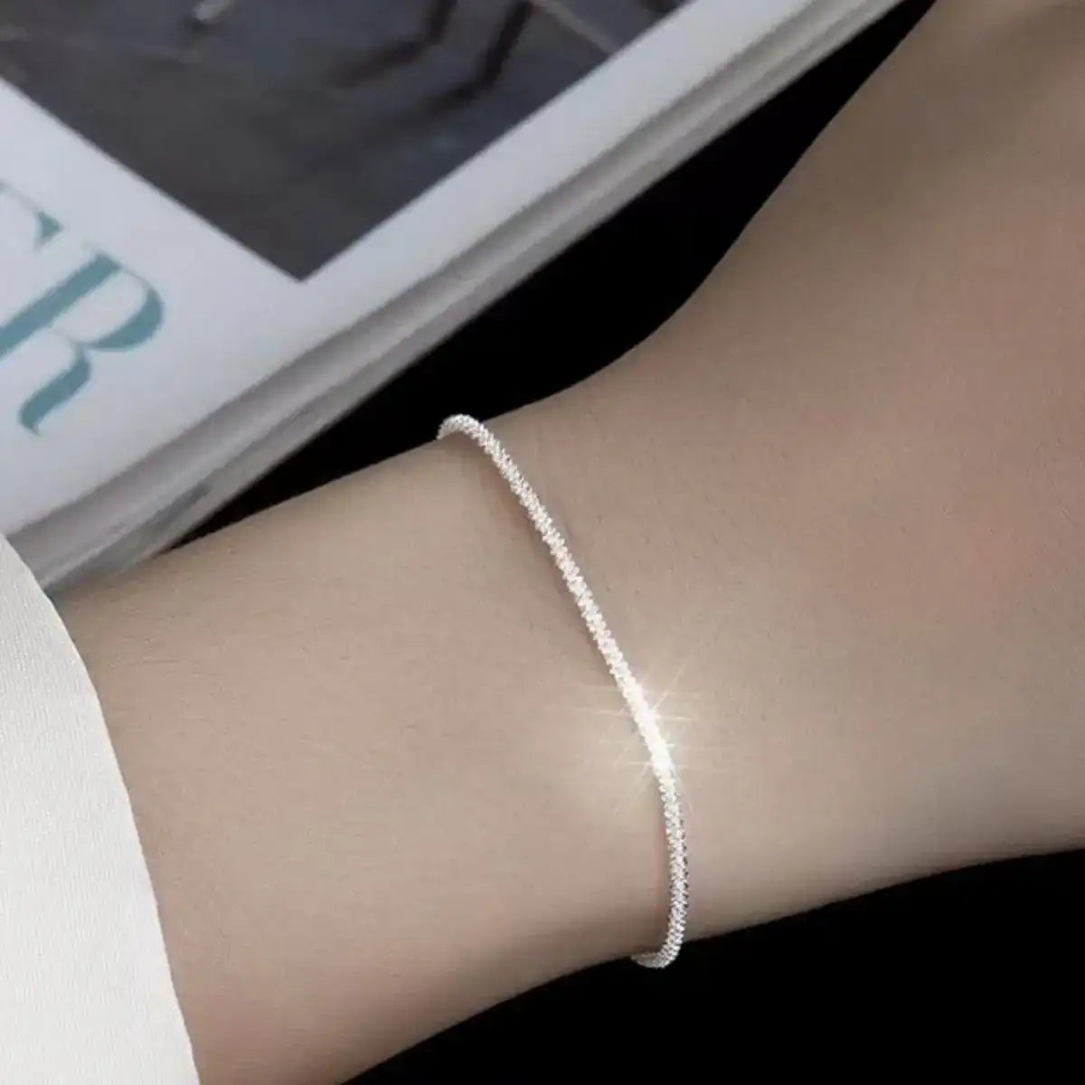 Evie's Dreamland 925 sterling silver adjustable chain bracelet worn on a woman's wrist.