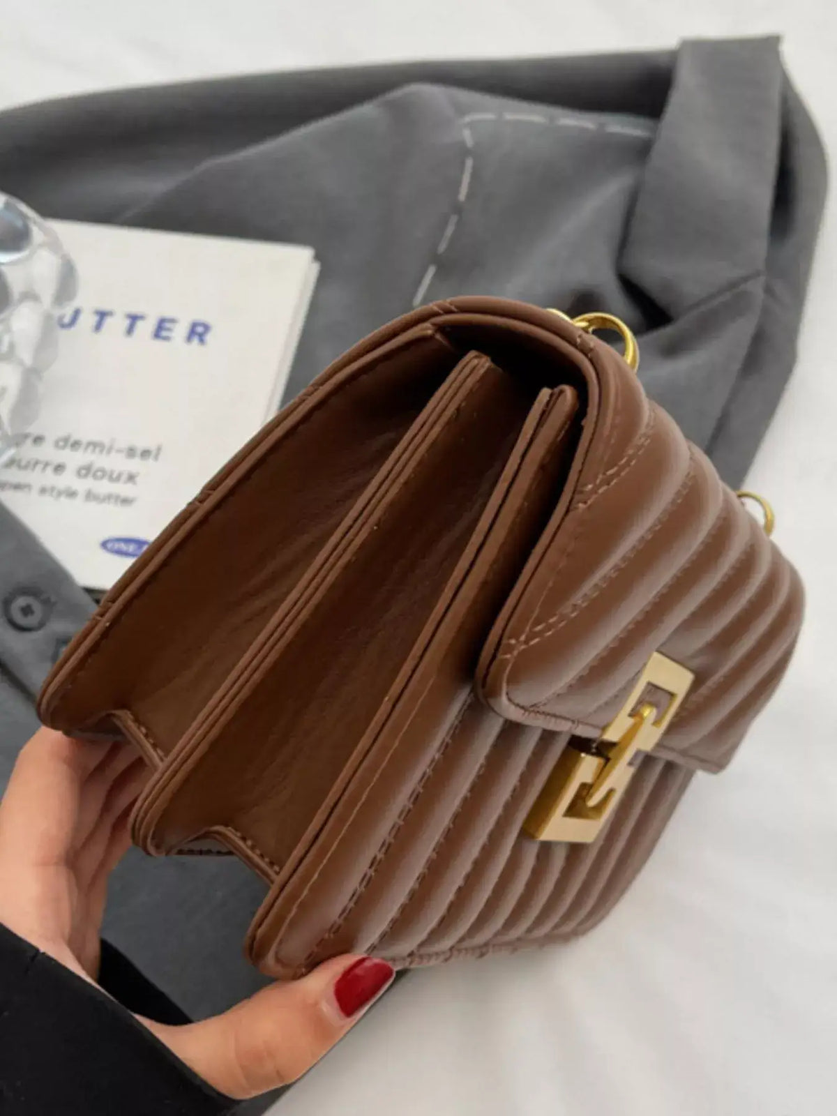 Brown quilted flap chain shoulder bag by Evie's Dreamland with gold hardware and PU leather finish.