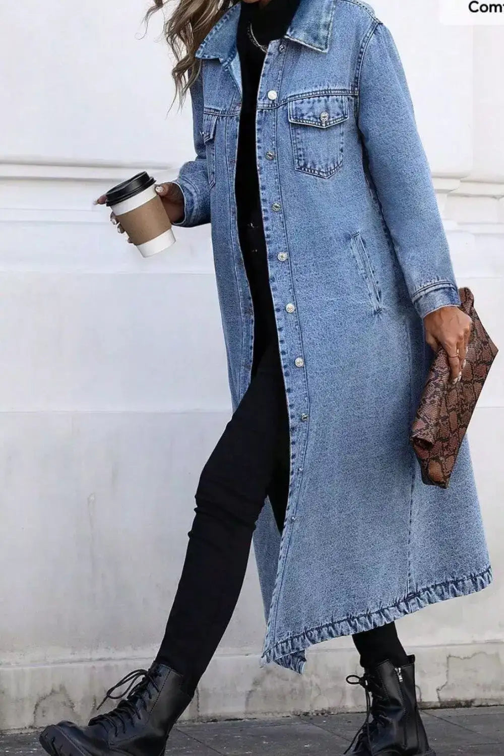 Woman wearing a light wash longline denim jacket by Evie's Dreamland with black pants and boots.