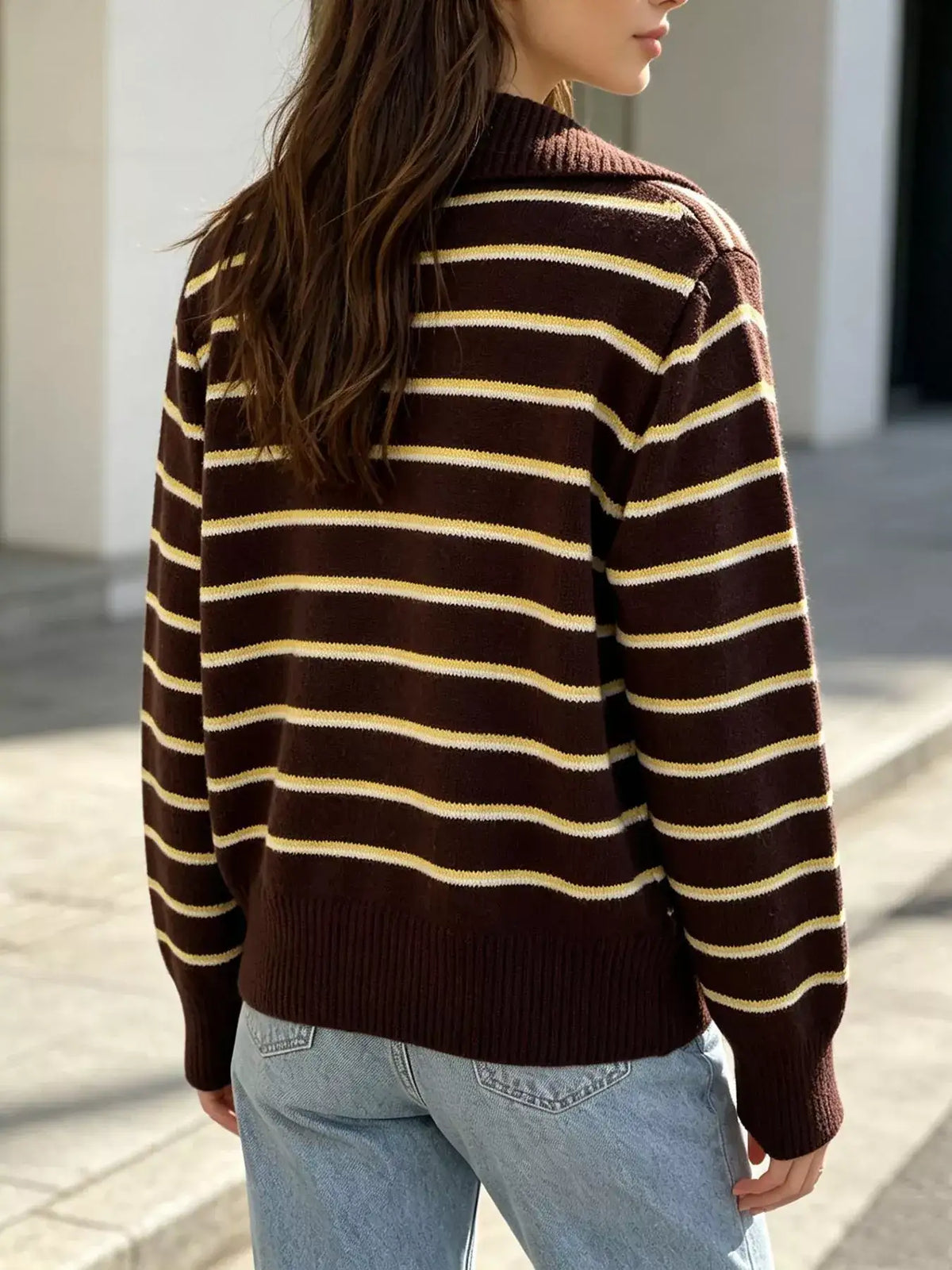 Back view of a brown and yellow striped polo collar sweater by Evie's Dreamland paired with blue jeans.
