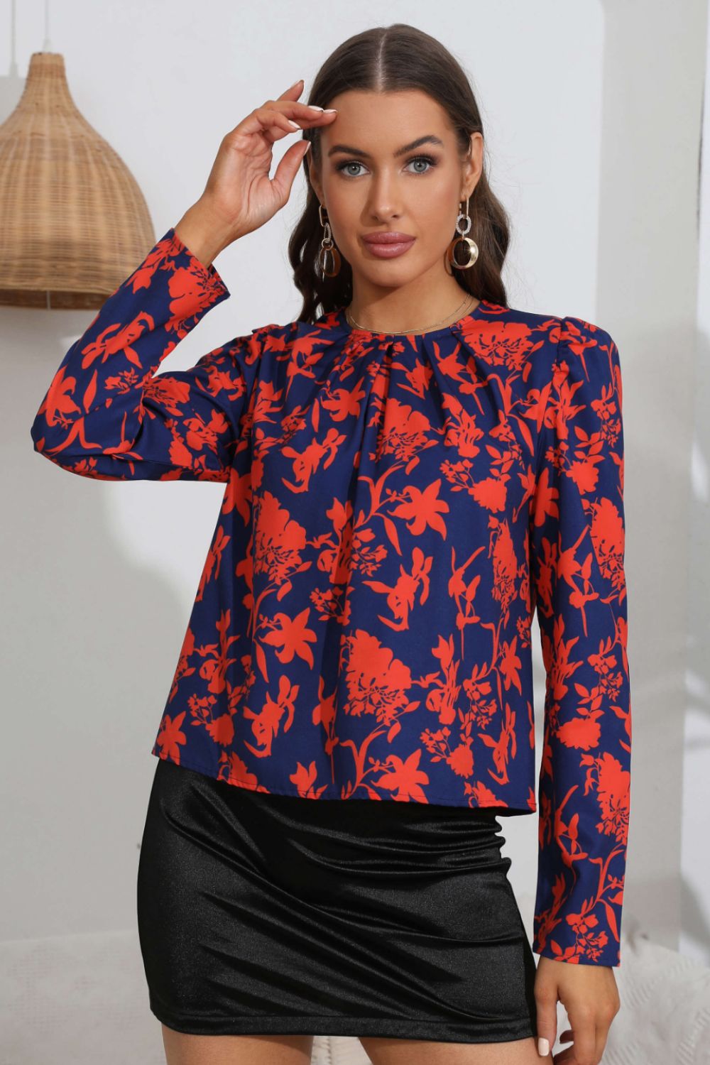 Navy blue floral blouse with red print, paired with black satin skirt for chic everyday elegance