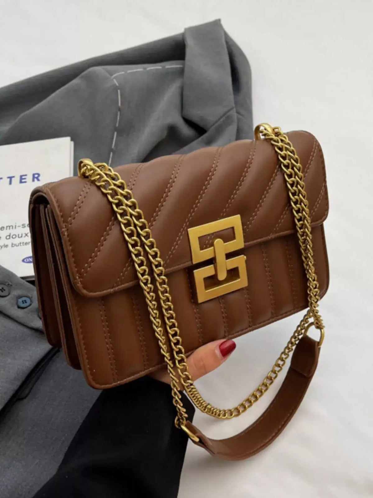 Brown quilted PU leather flap shoulder bag by Evie's Dreamland with gold chain strap and clasp.