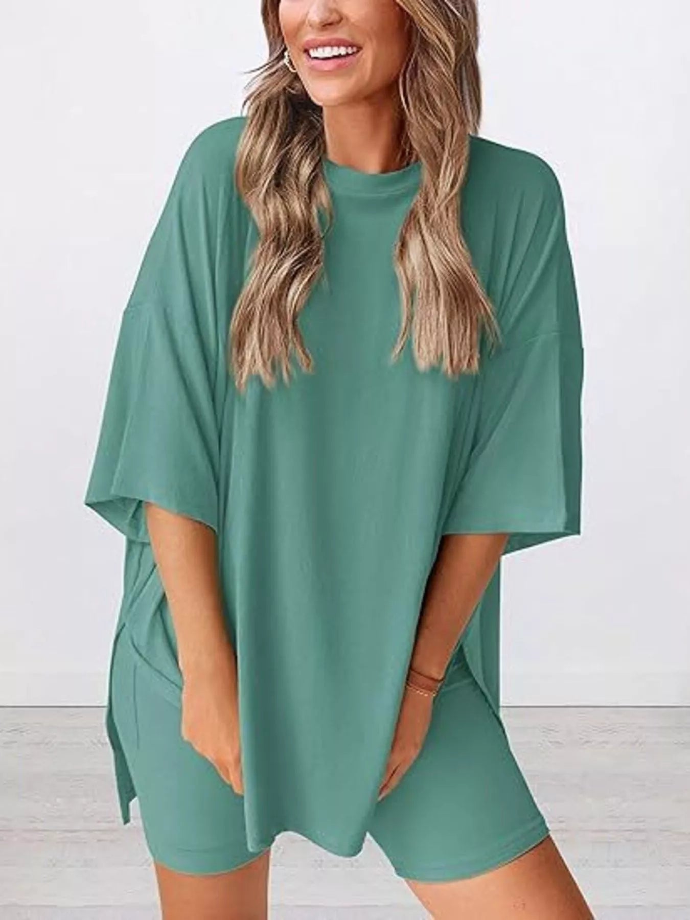 Woman wearing loose teal oversized t-shirt and matching shorts, casual lounge outfit