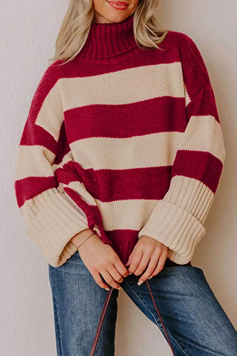 Evie's Dreamland red and beige striped turtleneck sweater with oversized fit and long sleeves.