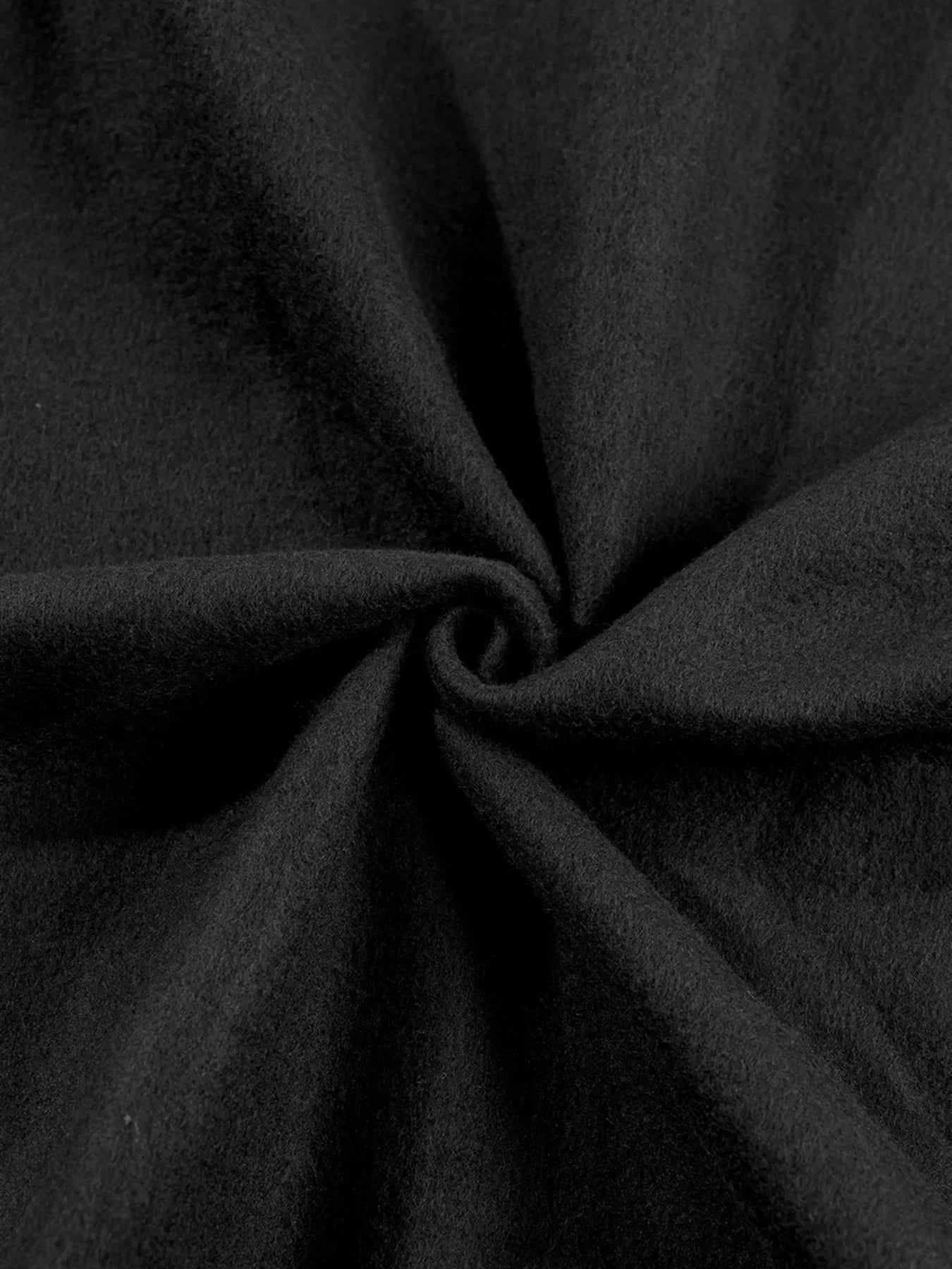 Close-up of black wool fabric with soft texture and elegant folds