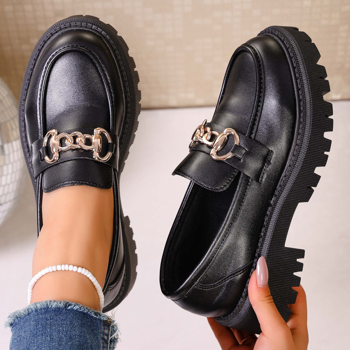 Back view of chunky heel chain decor loafers in black