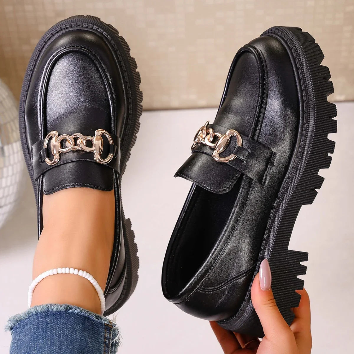 Back view of chunky heel chain decor loafers in black