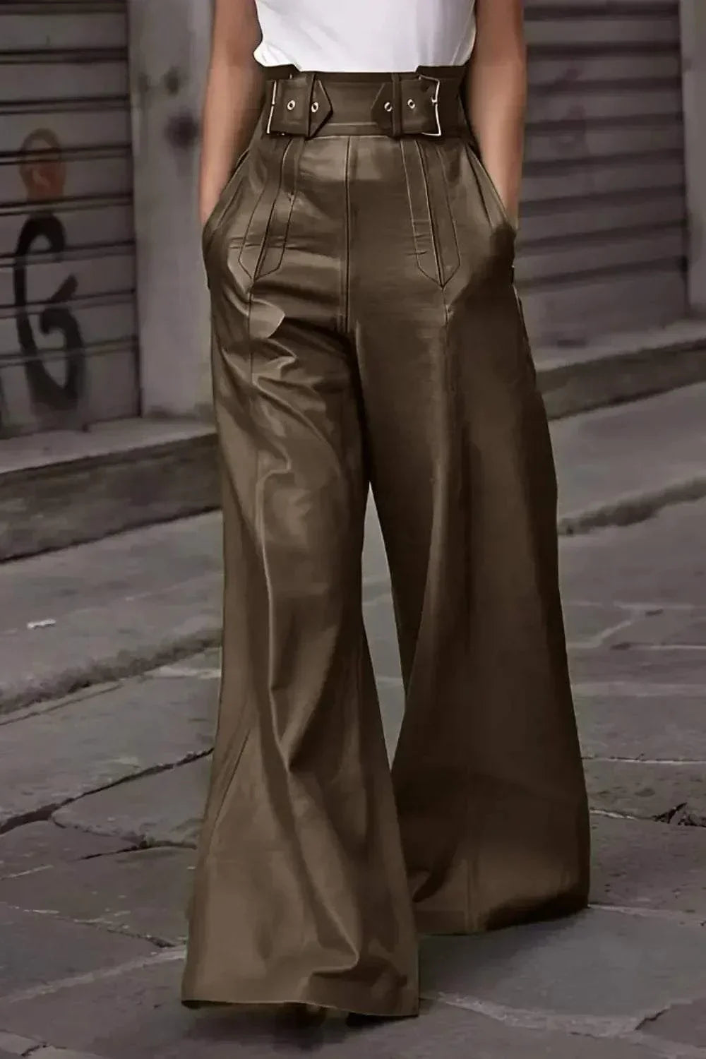 Close-up of high-waisted brown wide-leg leather pants with belt and pockets on city street