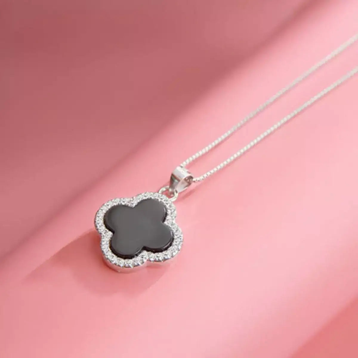 Evie's Dreamland 925 sterling silver clover pendant necklace with a black center and crystal border.