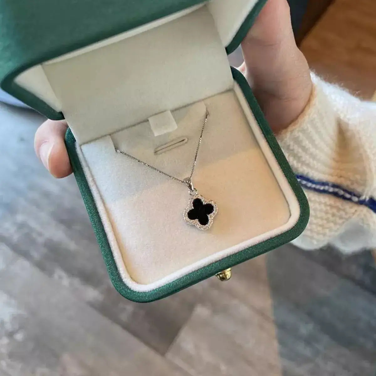 Evie's Dreamland 925 sterling silver clover pendant necklace with black onyx in a green gift box.