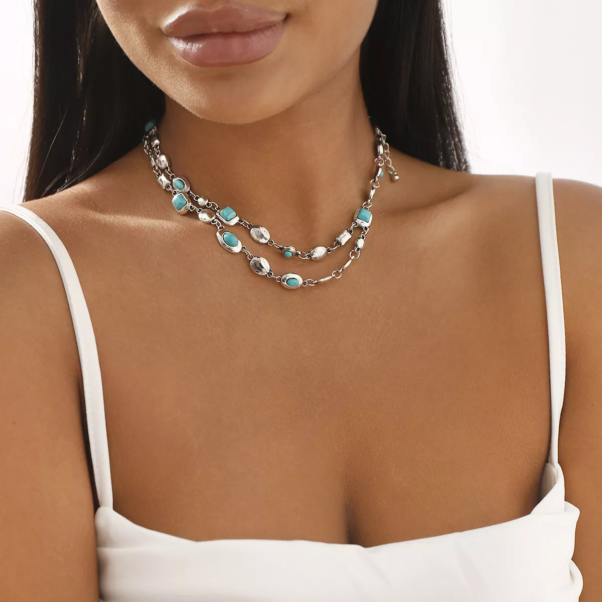 Layered silver necklace with turquoise stones, stylish fashion accessory for everyday elegance