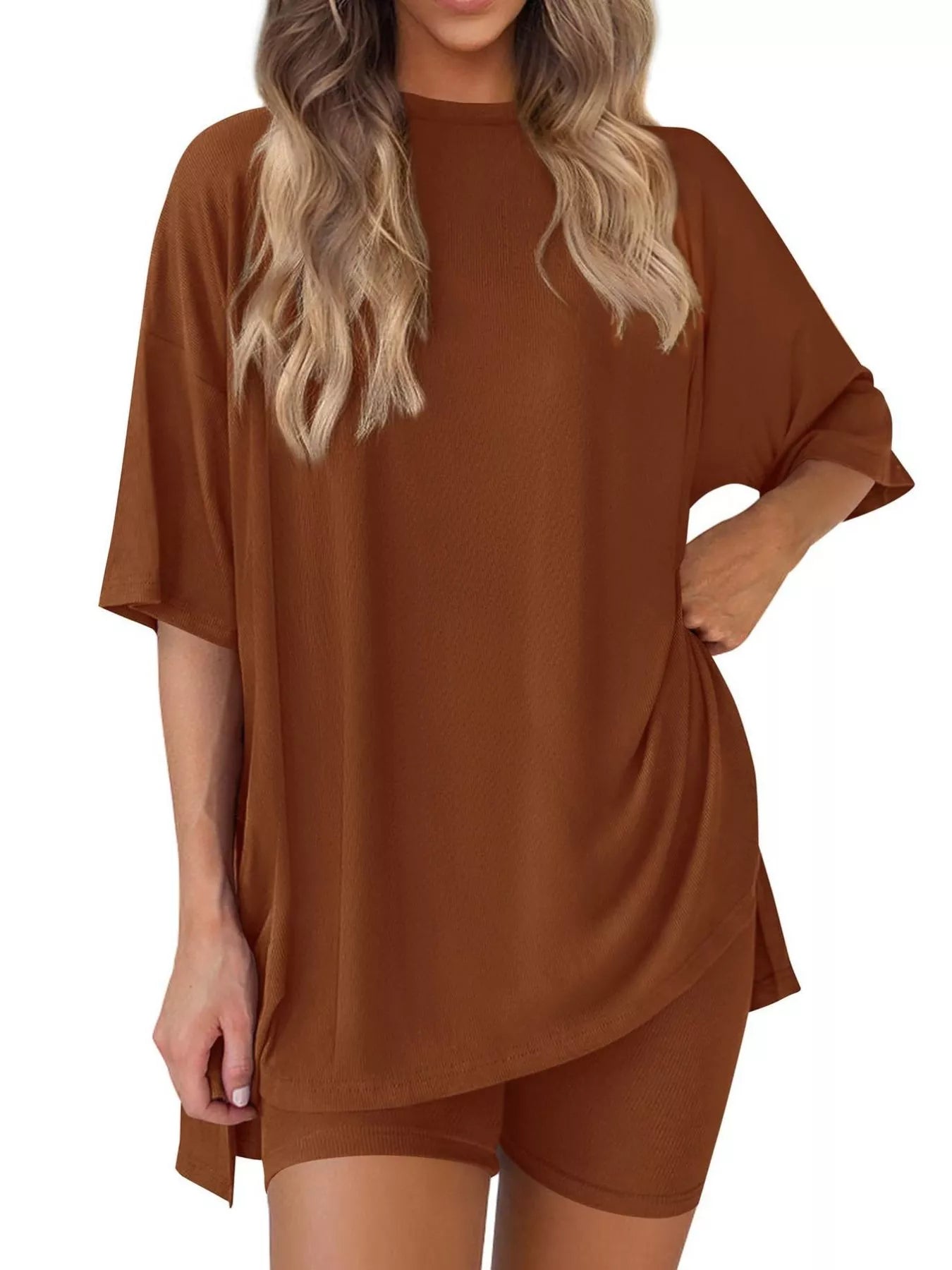 Woman wearing oversized brown lounge set with short sleeves and matching shorts
