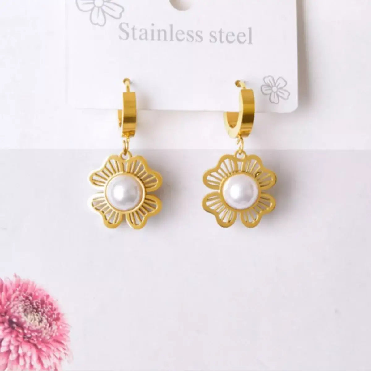Evie's Dreamland 18K gold-plated hoop earrings with flower designs and center white pearls.