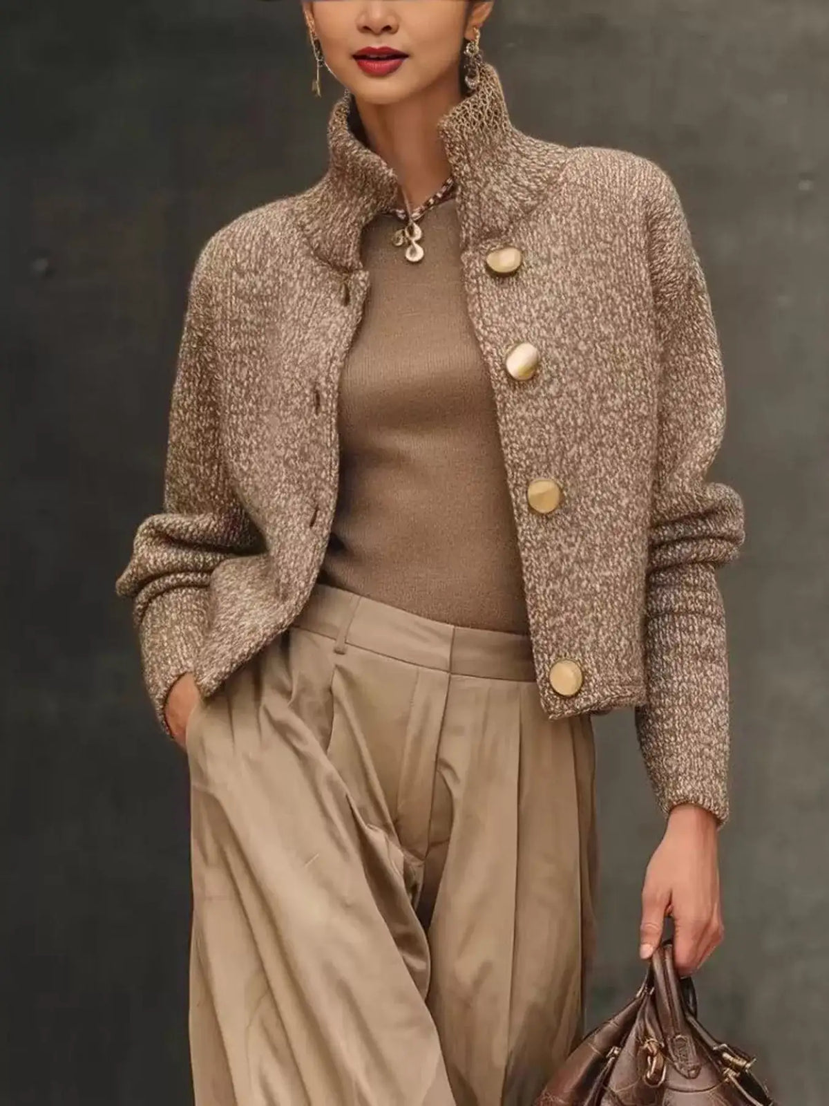 Evie's Dreamland brown button-down long sleeve cardigan with high neck and gold buttons paired with beige pants.