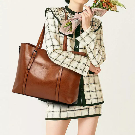 Woman in a plaid set carrying a brown PU leather large tote bag