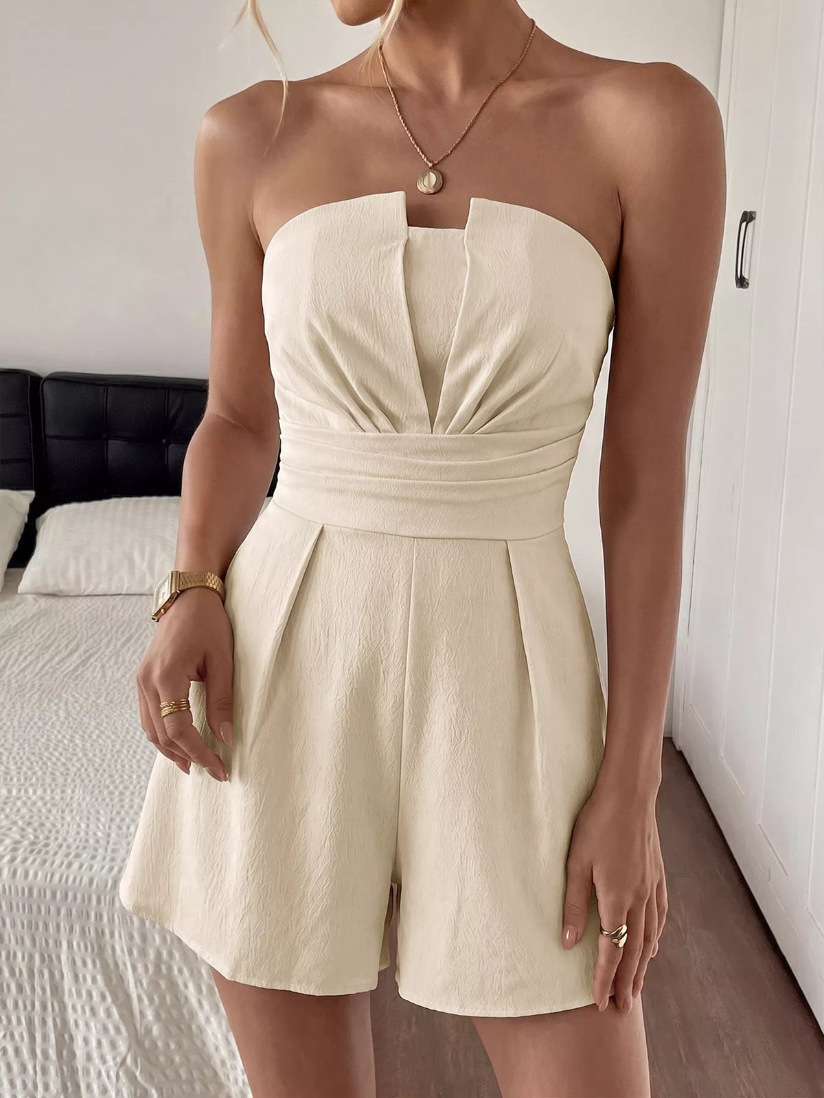 Apricot strapless pleated romper with smocked bodice, front view