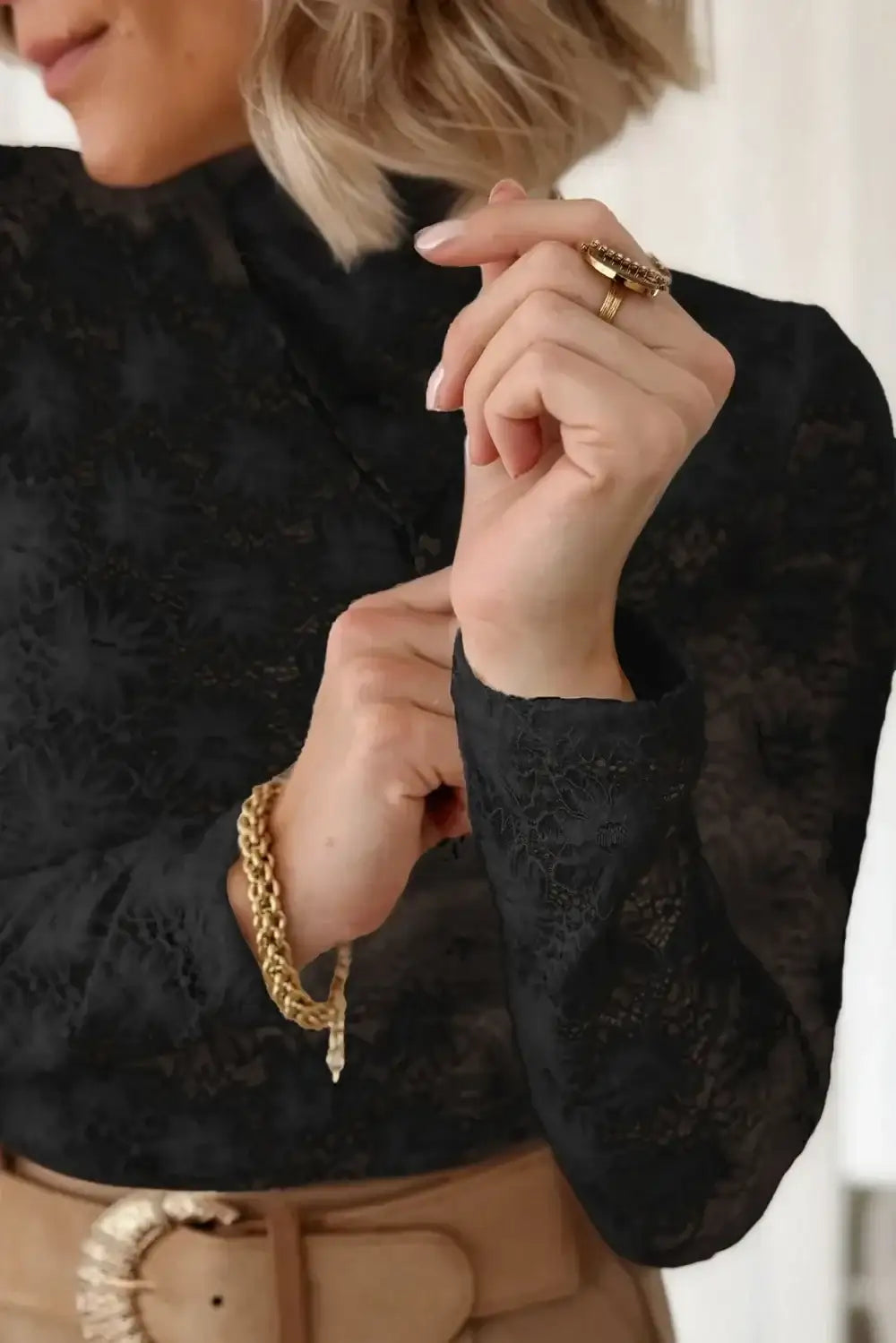 Close-up of a woman wearing a black lace mock neck long sleeve blouse by Evie's Dreamland.