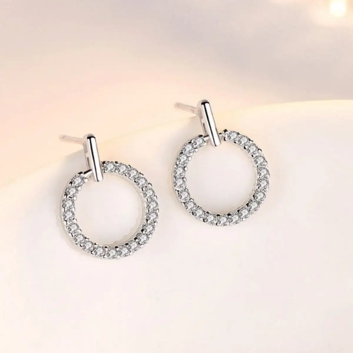 Evie's Dreamland 925 sterling silver circle stud earrings with sparkling pavé crystals.